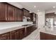 The kitchen features dark wood cabinets, stainless steel appliances, and a granite countertop at 21647 S 223Rd Pl, Queen Creek, AZ 85142