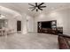 Spacious living room featuring tile floors, elegant archways, and a large entertainment center at 21647 S 223Rd Pl, Queen Creek, AZ 85142