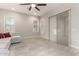 Bright living room with light-colored sofa, ceiling fan, and neutral flooring at 21647 S 223Rd Pl, Queen Creek, AZ 85142