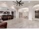 Bright and airy living room with an open floor plan, tile floors, and a comfortable leather sofa at 21647 S 223Rd Pl, Queen Creek, AZ 85142
