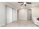 Open living room with tiled floors, neutral walls, and arched doorways, offering a bright and spacious feel at 21647 S 223Rd Pl, Queen Creek, AZ 85142