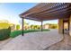 Spacious patio under a pergola complemented by artificial turf, mature landscaping, and a storage shed at 21647 S 223Rd Pl, Queen Creek, AZ 85142