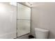 Clean shower-tub combination with white tiling and sliding glass door, providing a pristine bathing experience at 21647 S 223Rd Pl, Queen Creek, AZ 85142