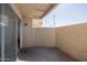 The private balcony provides an enclosed space with views of palm trees and a sliding glass door at 2646 N 43Rd Ave # B, Phoenix, AZ 85009
