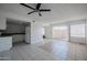 Open-concept living room features tile flooring, fan, and sliding glass door at 2646 N 43Rd Ave # B, Phoenix, AZ 85009