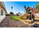 Large backyard with playground, seating area, and mature trees for outdoor enjoyment at 2962 E Dolphin Ave, Mesa, AZ 85204