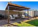 Cozy backyard patio seating area with a pergola, great for outdoor relaxation and entertainment at 2962 E Dolphin Ave, Mesa, AZ 85204