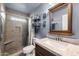 Updated bathroom featuring a neutral-toned tile shower, granite vanity, and decorative wall hangings at 2962 E Dolphin Ave, Mesa, AZ 85204