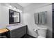 Functional bathroom with a marbled vanity top, updated light fixtures, and neutral wall color at 2962 E Dolphin Ave, Mesa, AZ 85204