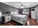 Comfortable bedroom with dark walls, white trim, and wood-look floors and plenty of natural light at 2962 E Dolphin Ave, Mesa, AZ 85204