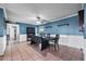 Spacious dining area featuring wainscotting, tile floors, and a large table at 2962 E Dolphin Ave, Mesa, AZ 85204
