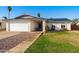 Charming single-story home featuring a well-manicured lawn, desert landscaping, and solar panels at 2962 E Dolphin Ave, Mesa, AZ 85204