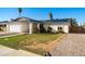 Attractive single-story house with a well-maintained lawn and desert landscaping at 2962 E Dolphin Ave, Mesa, AZ 85204
