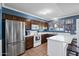 Traditional kitchen with stainless steel appliances, and tile floors, providing both functionality and rustic charm at 2962 E Dolphin Ave, Mesa, AZ 85204