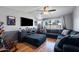 Comfortable living room featuring a large window, ceiling fan, and modern media center at 2962 E Dolphin Ave, Mesa, AZ 85204