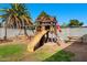 Well-equipped wooden playground set with a slide and swings, perfect for Gathering fun and recreation at 2962 E Dolphin Ave, Mesa, AZ 85204