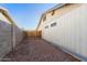 Practical side yard with gravel ground, providing storage and functionality to the property at 2962 E Dolphin Ave, Mesa, AZ 85204