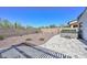 Landscaped backyard offers a private retreat with desert landscaping, a paved patio, and a relaxing hot tub at 29674 N 127Th Ln, Peoria, AZ 85383