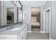 Bathroom showcasing a long vanity with double sinks and gray wood-look tile flooring at 29674 N 127Th Ln, Peoria, AZ 85383