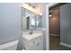 Bathroom with modern fixtures, a single sink vanity, and gray wood-look tile flooring at 29674 N 127Th Ln, Peoria, AZ 85383