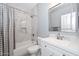 Bathroom featuring a shower-tub combo with marble tile and a single sink vanity at 29674 N 127Th Ln, Peoria, AZ 85383
