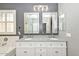 Bright bathroom featuring double sinks, a granite countertop, and a large window for natural light at 29674 N 127Th Ln, Peoria, AZ 85383