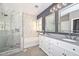 The bathroom features a dual sink vanity, a soaking tub, and a glass-enclosed shower with marble surround at 29674 N 127Th Ln, Peoria, AZ 85383