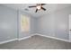 Bedroom featuring wood-look tile flooring and a window with white shutters at 29674 N 127Th Ln, Peoria, AZ 85383