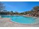 Large community pool with a gradual entry and numerous lounge chairs surrounding the pool area at 29674 N 127Th Ln, Peoria, AZ 85383