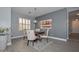 This dining room features a round wood table set on a patterned rug with natural light from a window at 29674 N 127Th Ln, Peoria, AZ 85383
