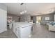 The kitchen features an island with a marble countertop, pendant lights, and modern appliances at 29674 N 127Th Ln, Peoria, AZ 85383