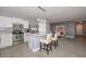 This stylish kitchen includes a large center island, pendant lighting, stainless appliances, and light gray walls at 29674 N 127Th Ln, Peoria, AZ 85383