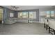 Cozy living area boasts a plush gray sectional, modern tiled floors, white window shutters, and stylish decor at 29674 N 127Th Ln, Peoria, AZ 85383