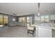Open-concept living space featuring gray walls, stylish tiled flooring, a comfortable sectional, and a well-lit kitchen at 29674 N 127Th Ln, Peoria, AZ 85383
