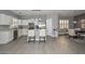 Open-concept living area with modern tile flooring, a kitchen island, and an adjacent dining area, perfect for hosting at 29674 N 127Th Ln, Peoria, AZ 85383