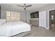 The bedroom has a TV, dresser, shuttered windows, and a ceiling fan at 29674 N 127Th Ln, Peoria, AZ 85383