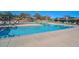 Resort-style swimming pool with ample deck space, lounge chairs, and shade umbrellas at 29674 N 127Th Ln, Peoria, AZ 85383