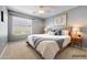 Inviting bedroom featuring wood-frame bed, side tables, blanket, and a large window with natural light at 3005 W Donatello Dr, Phoenix, AZ 85086