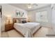 Comfortable bedroom with neutral decor, wood-frame bed, side tables, and a bright window at 3005 W Donatello Dr, Phoenix, AZ 85086