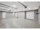 Large garage with speckled flooring, white walls, and access doors at 3005 W Donatello Dr, Phoenix, AZ 85086