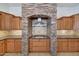 Gourmet kitchen with beautiful stone-surround gas range, custom cabinetry, and granite countertops at 3005 W Donatello Dr, Phoenix, AZ 85086