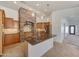 Modern kitchen featuring a granite island, stainless steel appliances, and a decorative stone hood at 3005 W Donatello Dr, Phoenix, AZ 85086