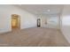 Bright living room featuring neutral paint, carpet, and window shutters at 3005 W Donatello Dr, Phoenix, AZ 85086