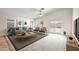 Bright living room with large windows, plush seating, and sliding glass doors to the backyard at 3005 W Donatello Dr, Phoenix, AZ 85086