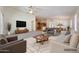 Bright open-concept living room with ceiling fan, stylish furnishings, and seamless flow to dining area at 3005 W Donatello Dr, Phoenix, AZ 85086
