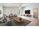 Bright living room with large windows, plush seating, and sliding glass doors to the backyard at 3005 W Donatello Dr, Phoenix, AZ 85086