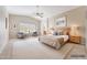 Serene main bedroom retreat with vaulted ceiling, ceiling fan, plantation shutters, and cozy seating area at 3005 W Donatello Dr, Phoenix, AZ 85086