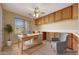 Functional home office featuring built-in cabinets, a large desk, and a comfortable armchair at 3005 W Donatello Dr, Phoenix, AZ 85086