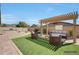 Relaxing outdoor living space with pergola, lounge seating, fire pit, and manicured landscaping at 3005 W Donatello Dr, Phoenix, AZ 85086