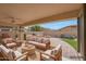 Inviting outdoor living space with plush seating, fireplace, built-in grill, and waterfall feature at 3005 W Donatello Dr, Phoenix, AZ 85086